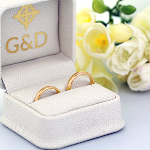 18K yellow gold wedding rings in a box