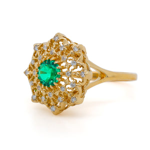 Side view of the Diamond Lace Emerald Ring in 18K yellow gold, featuring open lace-inspired filigree, natural diamonds, and a round Colombian emerald center.