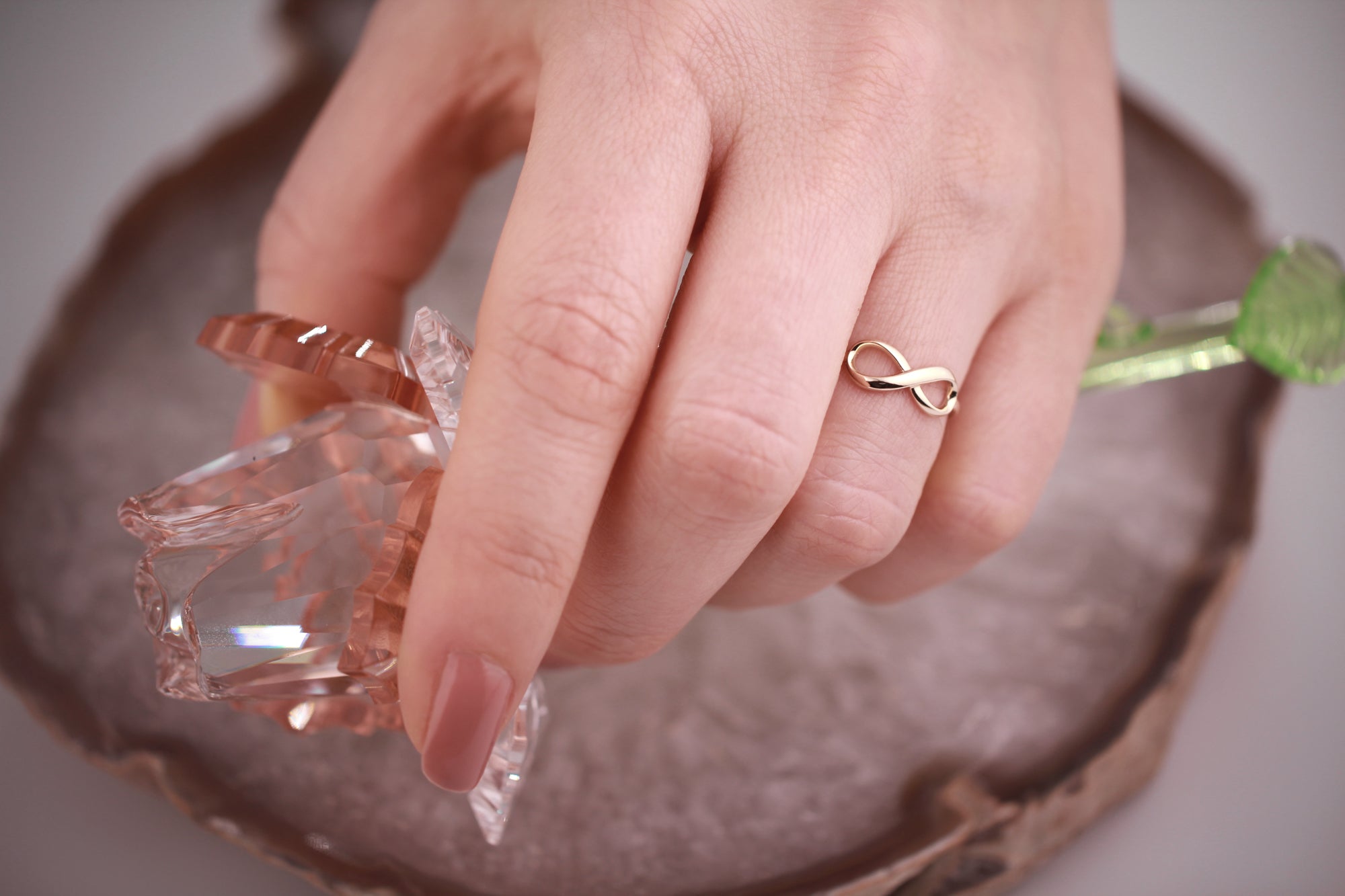 Infinity Ring in 14K Gold worn on hand close-up