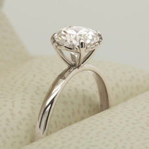 moissanite engagement ring with fleur de lis in white gold