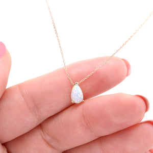 Small opal drop necklace shown to scale on hand