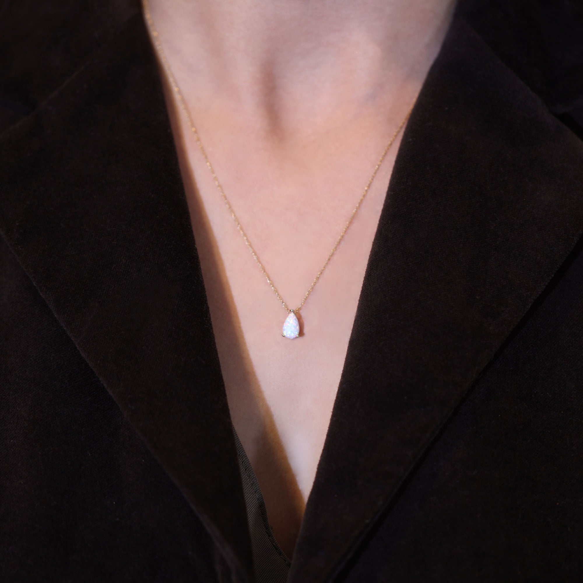 Opal necklace teardrop pendant on model neckline