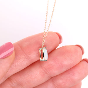 Small opal drop necklace side view shown to scale on hand