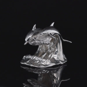 Sterling Silver sculpture of a pair of Dolphins on the waive