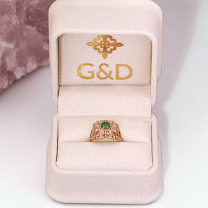 emerald ring with diamonds in a gift box