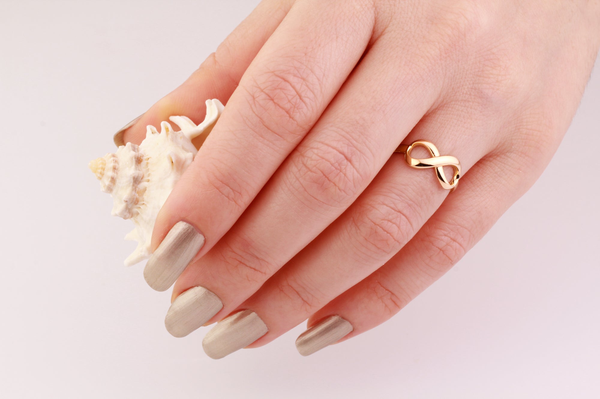 14k solid yellow gold infinity ring on the hand