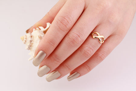 14k solid yellow gold infinity ring on the hand