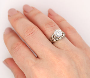 gold Fleur de lis engagement ring with moissanite